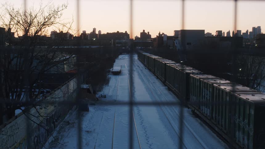 The cargo containers are parked on the train tracks