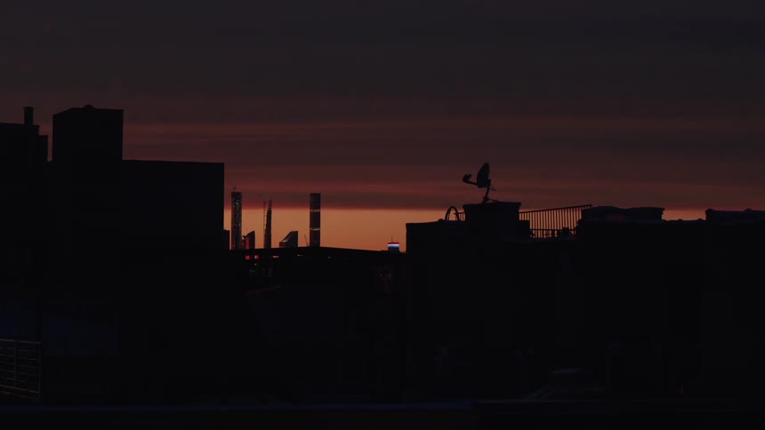 Skyline of the rooftops of buildings in the city at sunset