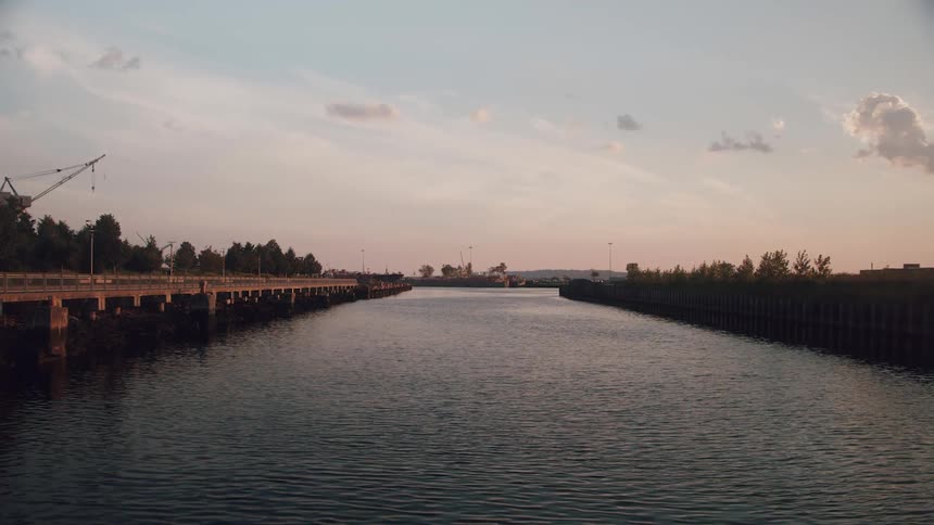 The sun is setting in the horizon on a body of water