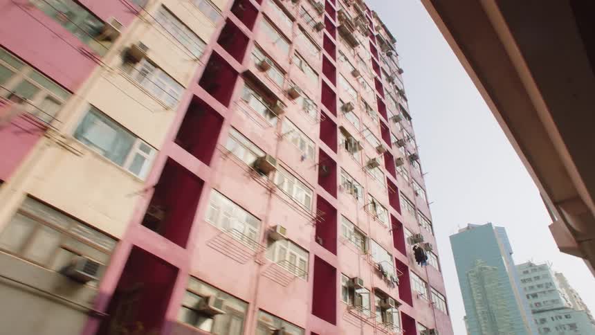 Pink apartment buildings next to bridge in the city
