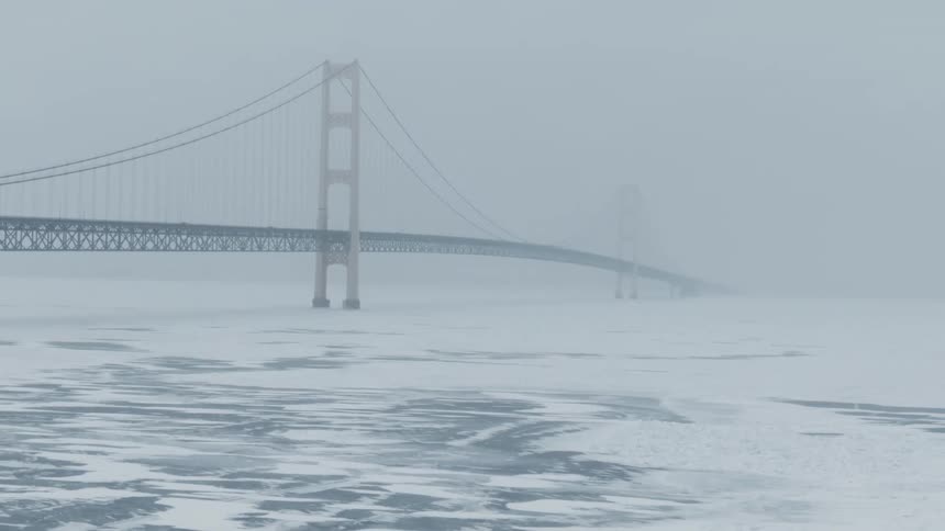 Aerial view of a frozen body of water in winter is displayed