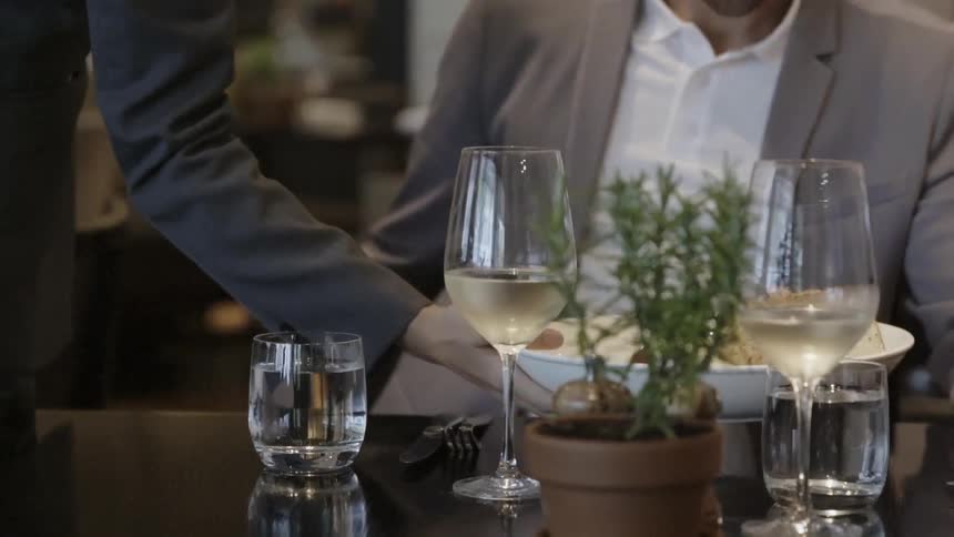 Food is served to a patron in a restaurant