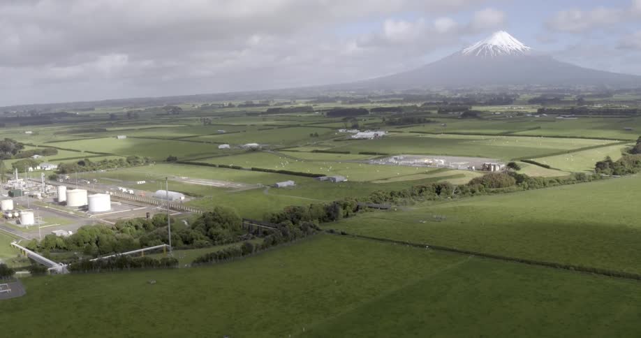 Aerial view of a farm with silos and green grass
