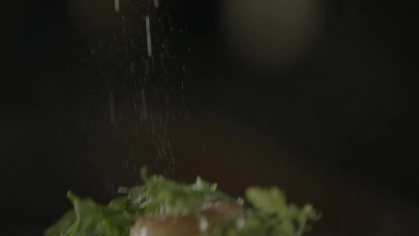 Salt is poured on a dish of food