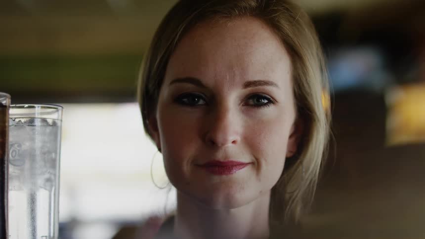 A woman smiles in the room