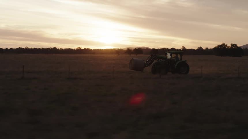 A tractor speeds through a field