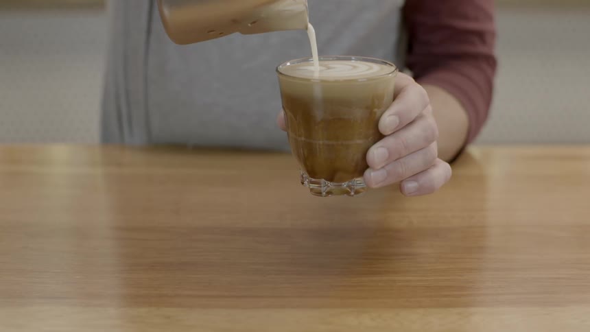 Cream is being poured into a glass