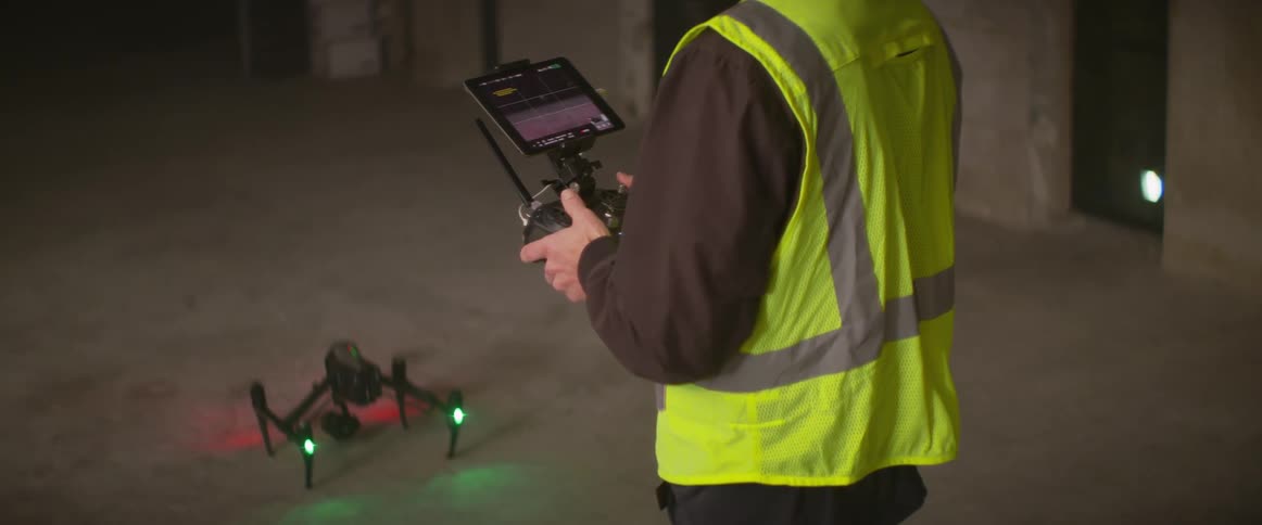 A man is flying a drone at night