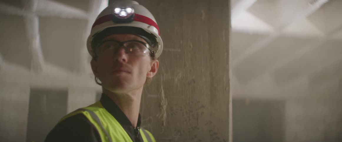 A construction worker looks around in the building