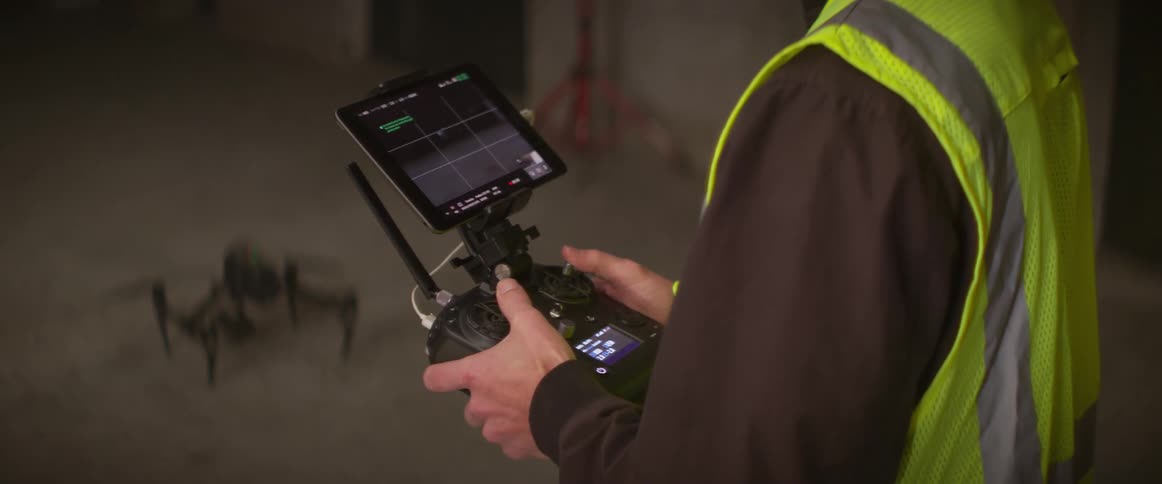 A man lands the drone on the concrete