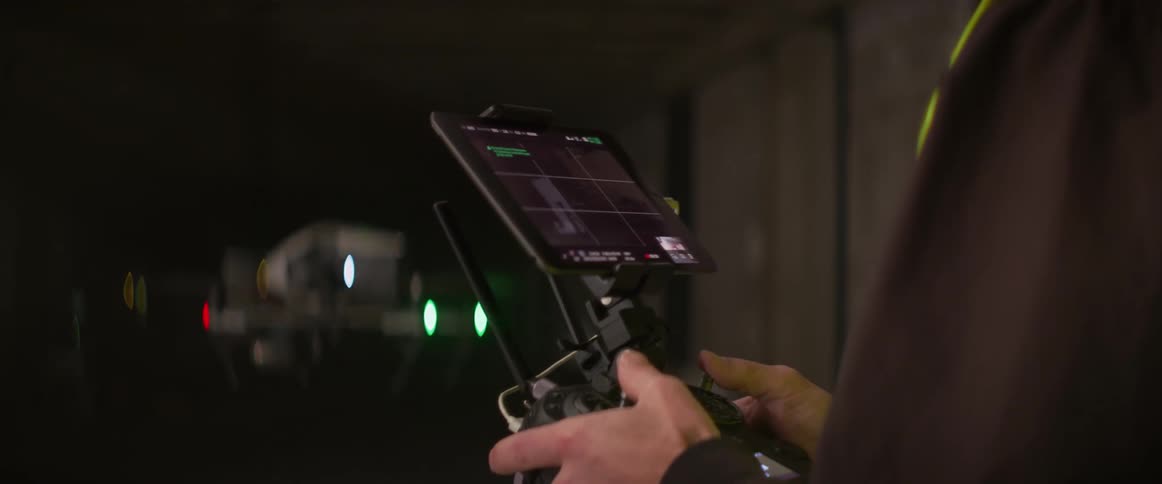 A man is flying a drone outside at night