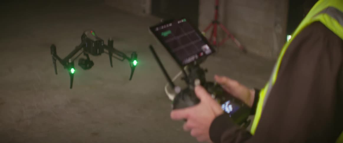A man is flying a drone at night