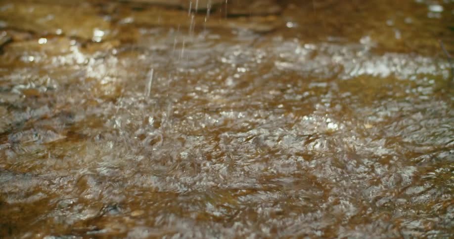 Person splashes as they run through flowing water