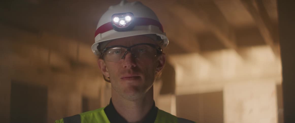 A construction worker has his head light on