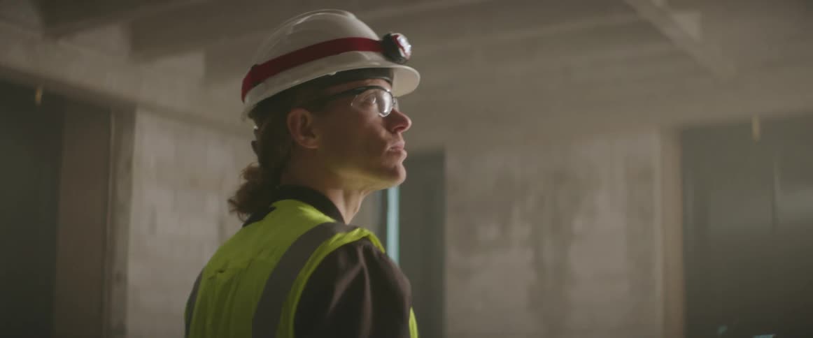 A construction worker is walking through the site