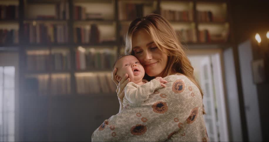 Mother sways while holding baby