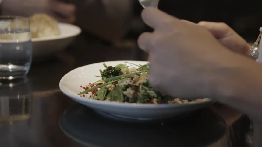 Close up of plates of food as people eat