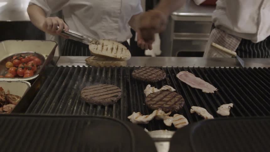 Chefs prepare cook food on a grill