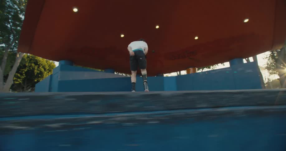 A man is skating on his skateboard in the park