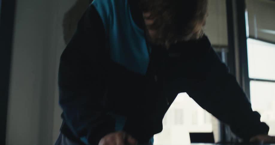 A man practices on his skateboard in the room