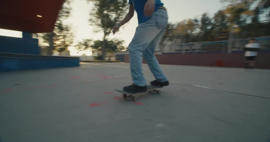 A man jumps and spins in the air on his skateboard