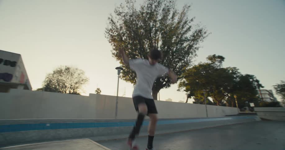 A man with a prosthetic leg skateboards and almost performs a trick
