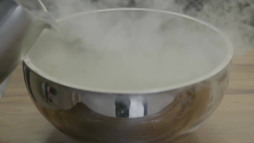 Water is poured on a bowl of flash frozen food