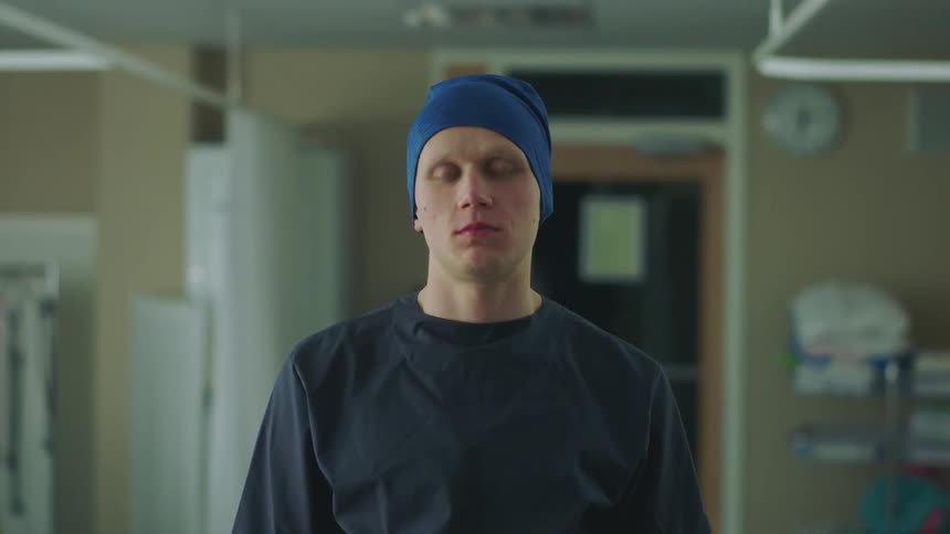 Man wearing head covering poses in hospital room