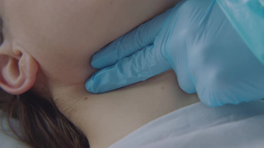 Medical personnel checks patients pulse