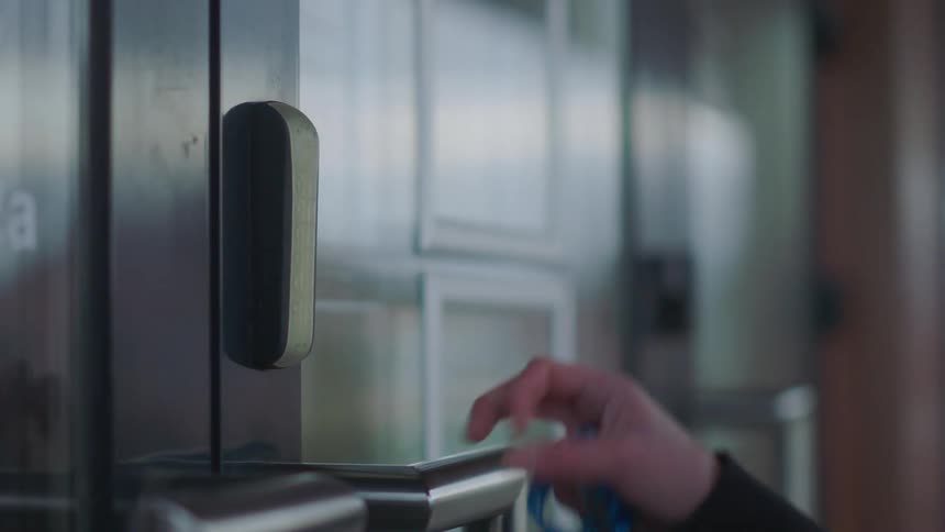 Someone uses their key card to open a door