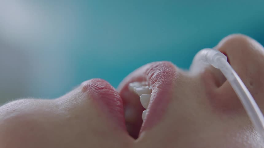 A hospital patient with a breathing tube gasping for breath