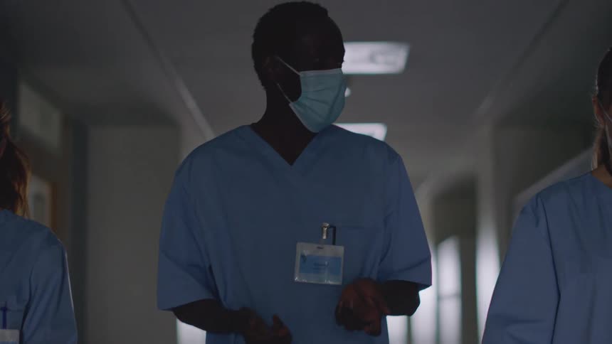 Nurses walks down hospital corridor talking
