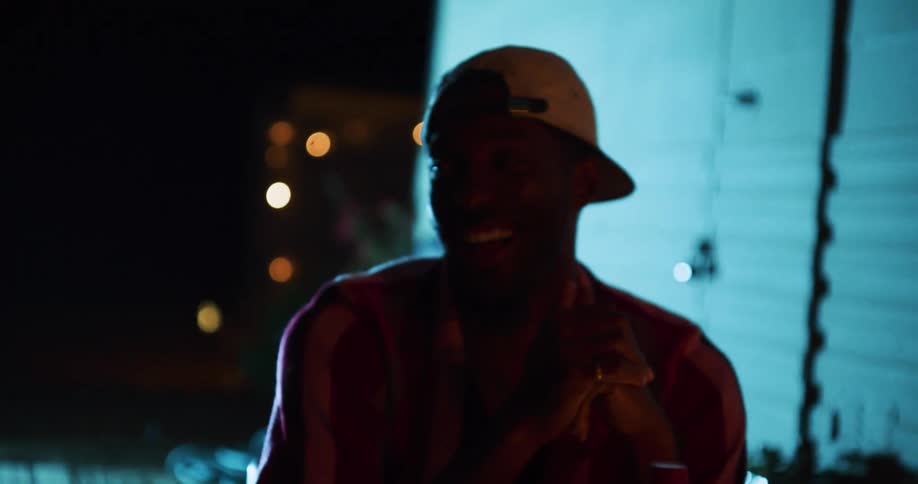 Couple talk and smile near mobile home at night