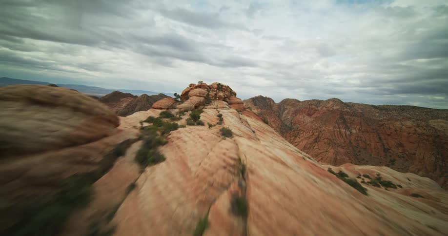 A large canyon sits between large clay formations above the valley