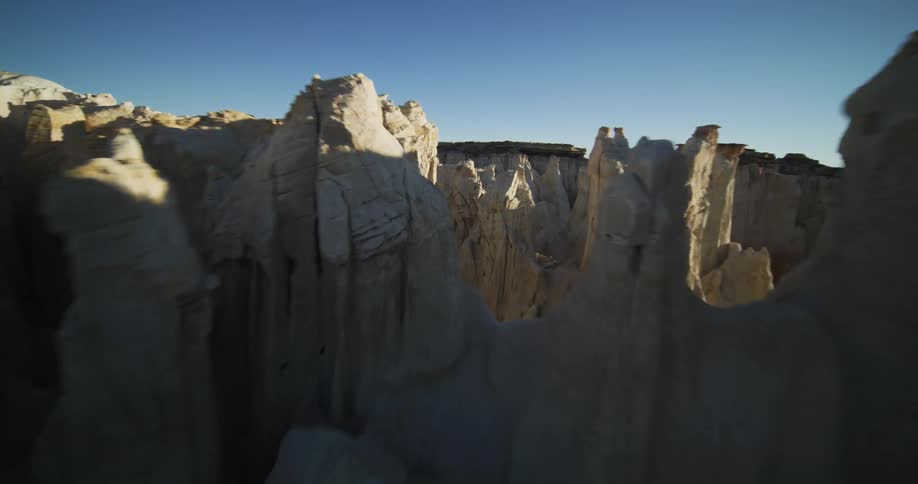 Tall formations protrude out from inside the desert canyon