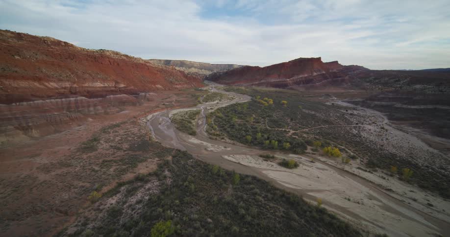 A dirt road winds through a canyon