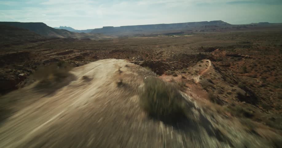 A foot path runs along the top of a narrow canyon