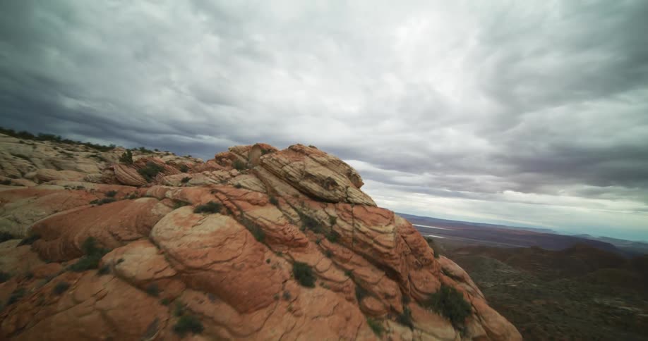 Clay and stone cliffs protrude up from the deep desert valley