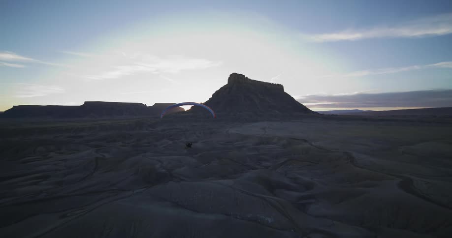 A person is gliding over a valley