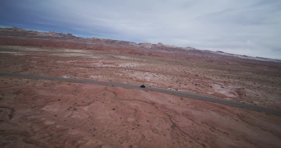 A car is driving through a mountainous area