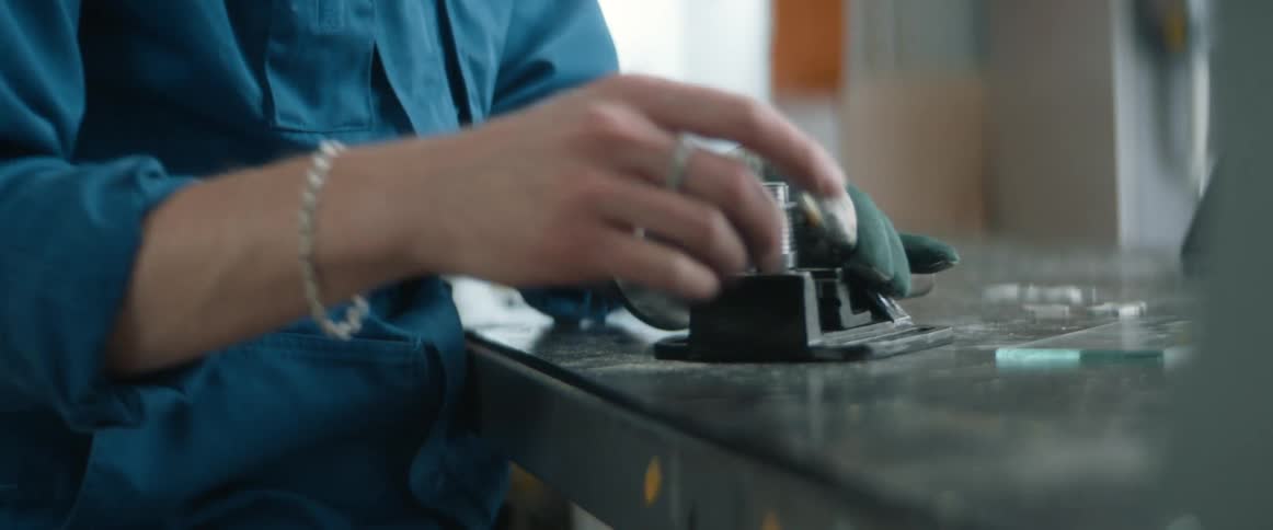 Person works on machine on workshop table