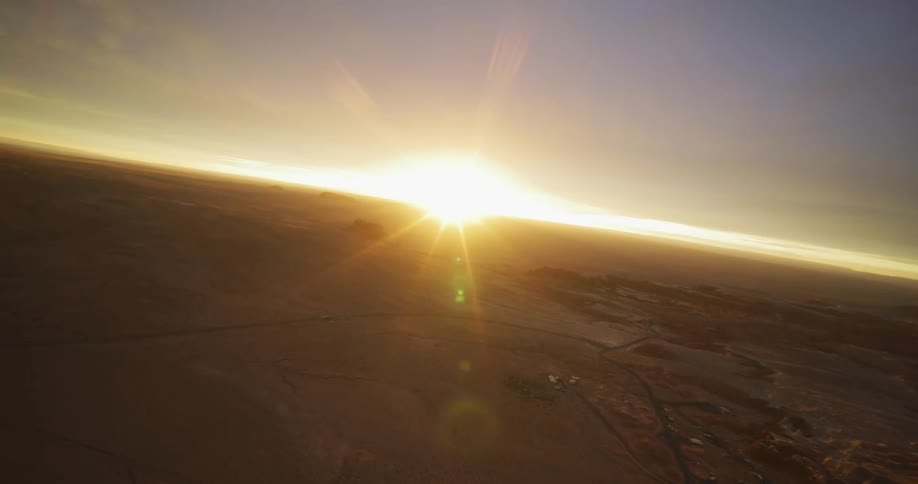 Dirt roads run through a vast desert