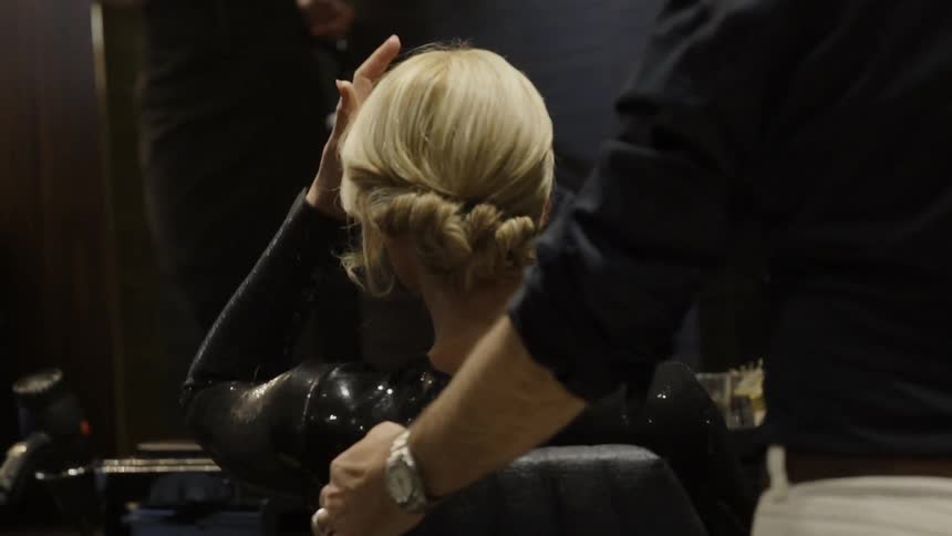 A woman seated gets spun in her chair