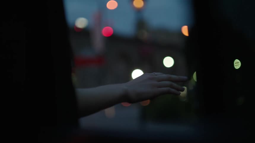 A hand being held out of a car window