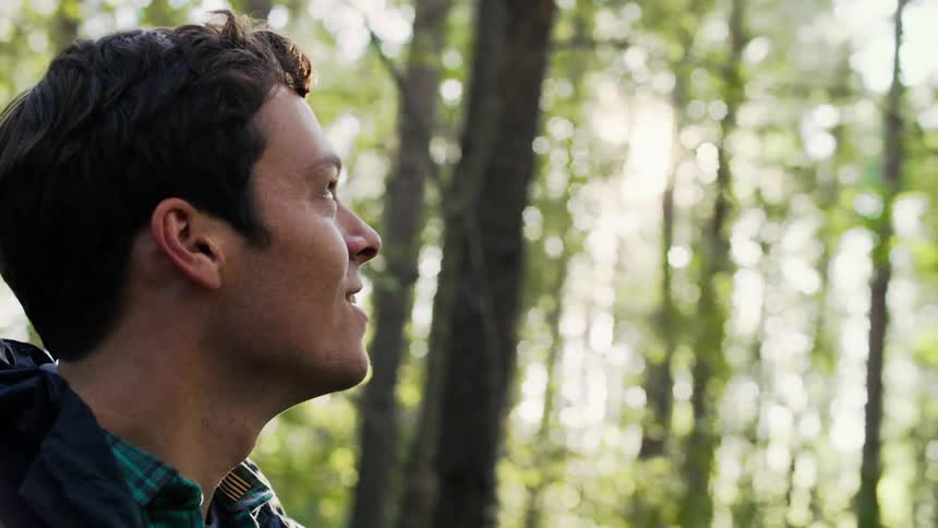 Young man standing in the forest