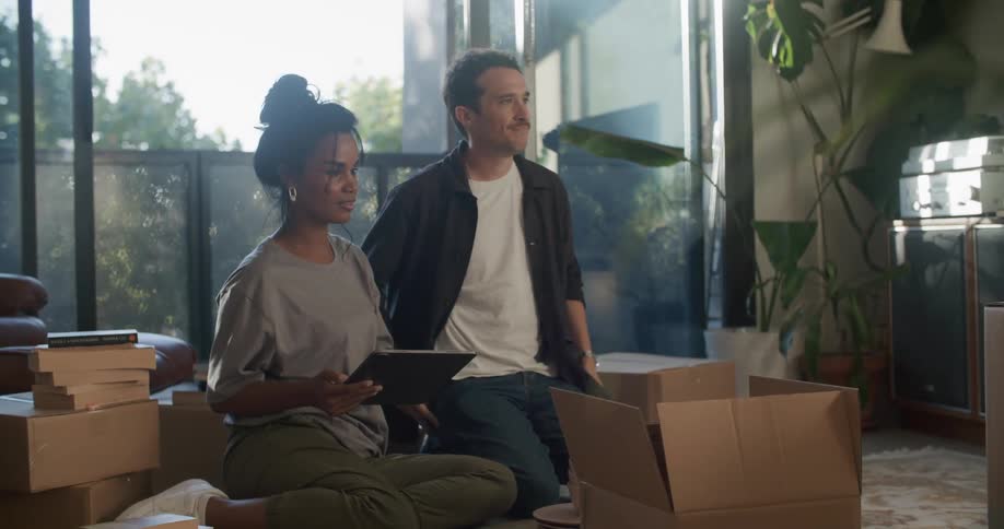 Woman and man are unpacking items in their house