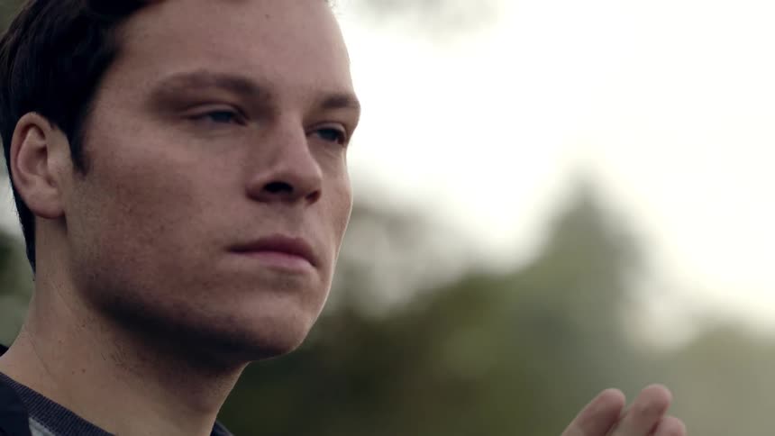 Young man thinking outdoors