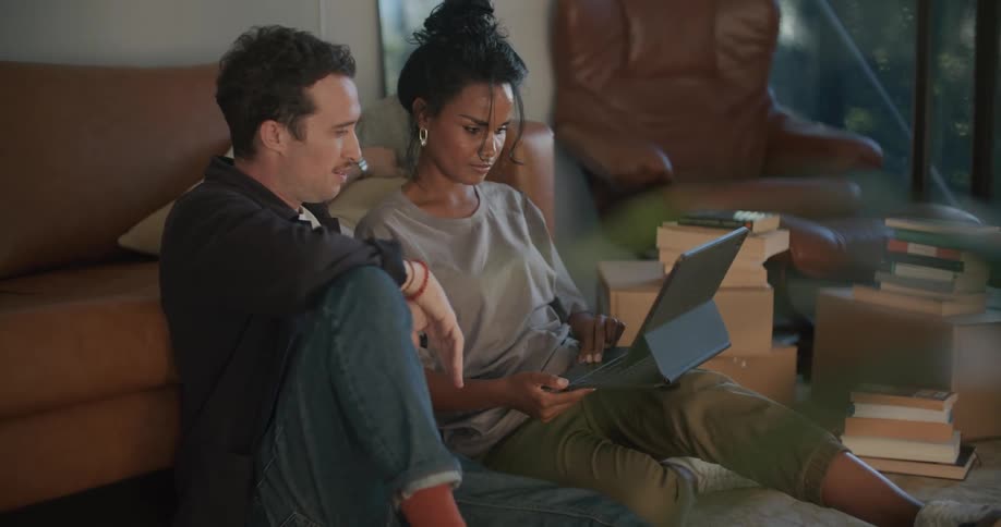 Two people talking and using a tablet