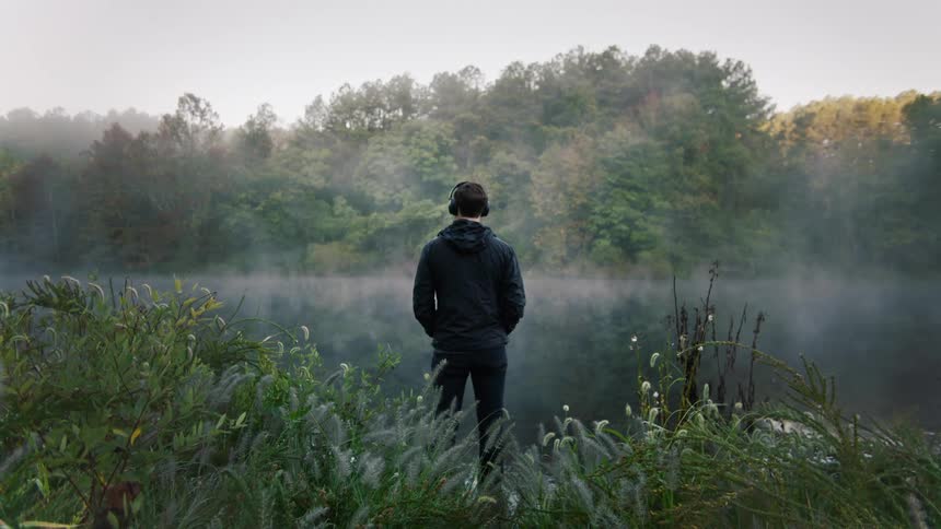 Young man at the river bank