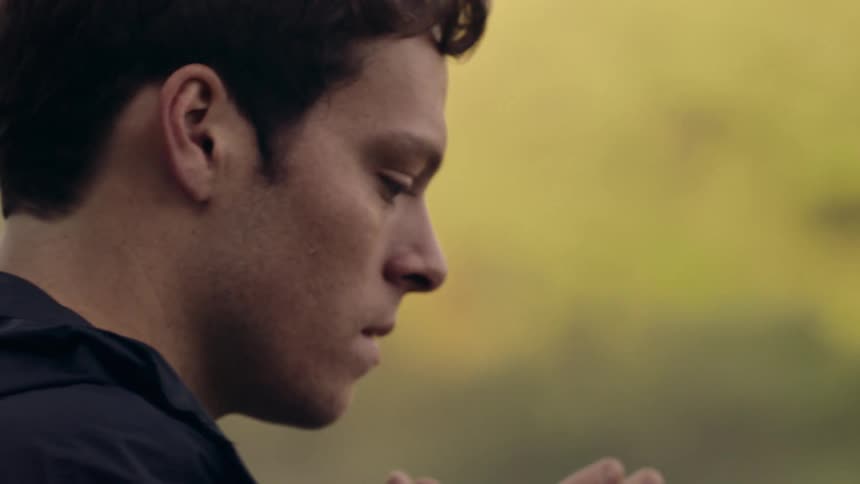 A person outdoors standing around thinking